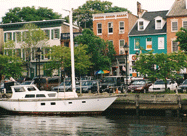 Fell's Point Thames Street Waterfront showing historic buildings and a docked sailboat Baltimore MD